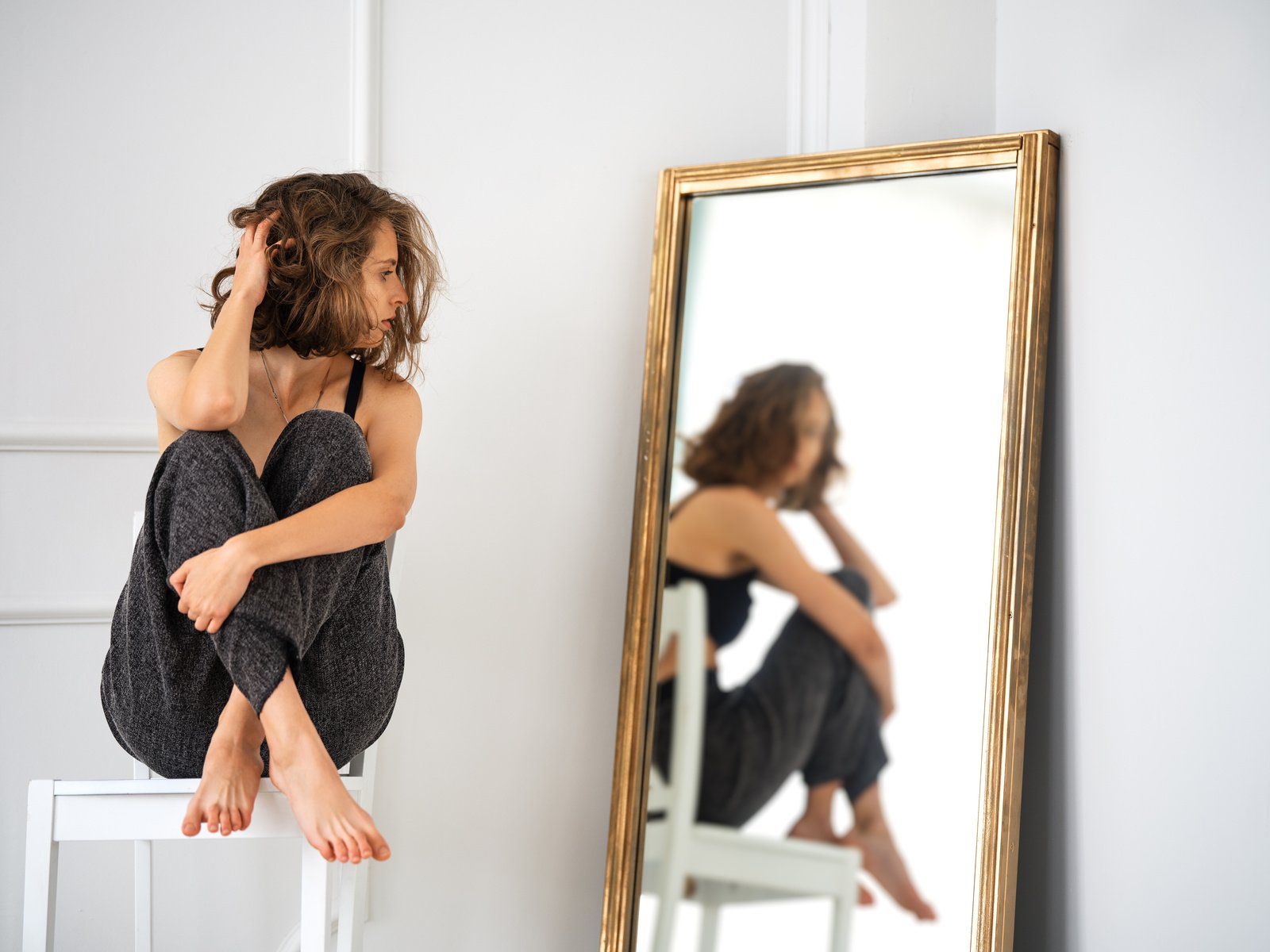 Reflection of a Woman Looking in the Mirror