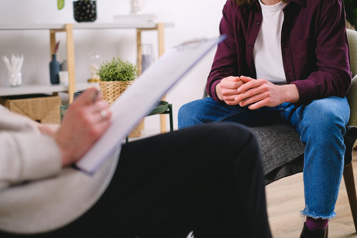 Man Sitting in Chair at Psychotherapy Session